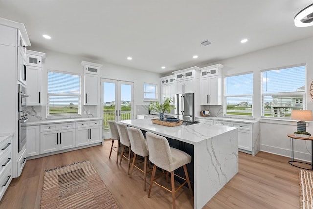 21330 Scissor Tail Ln, Galveston, TX 77554 - kitchen with high end refrigerator, healthy amount of natural light, a center island, and recessed lighting