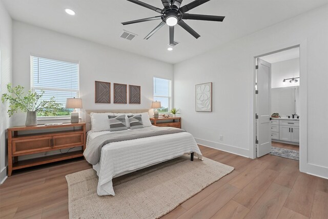 21330 Scissor Tail Ln, Galveston, TX 77554 - bedroom with light wood-type flooring, recessed lighting, ensuite bathroom, and a ceiling fan