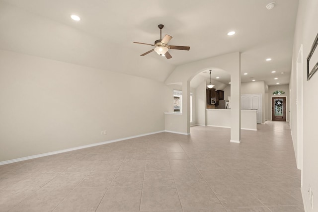 4211 Ponderosa Hills Ln, Katy, TX 77494 - unfurnished living room featuring a ceiling fan, light tile patterned floors, arched walkways, recessed lighting, and vaulted ceiling