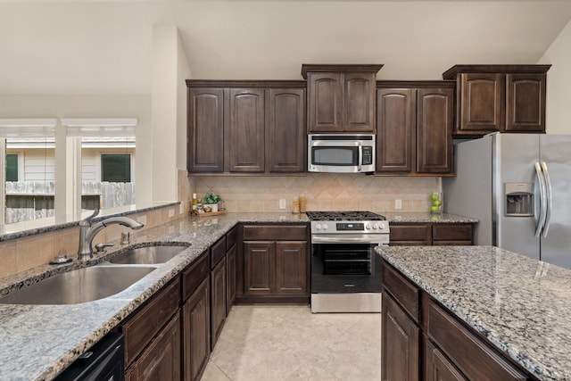 4211 Ponderosa Hills Ln, Katy, TX 77494 - kitchen with stainless steel appliances, light stone countertops, decorative backsplash, dark brown cabinetry, and light tile patterned floors