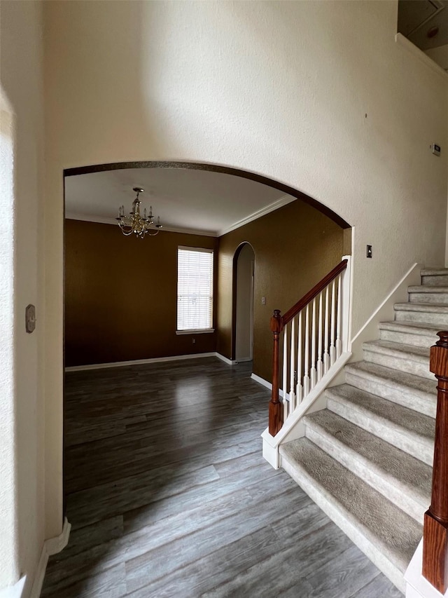 20019 Sterling Meadow Ct, Katy, TX 77449 - stairs with arched walkways, wood finished floors, ornamental molding, and a chandelier