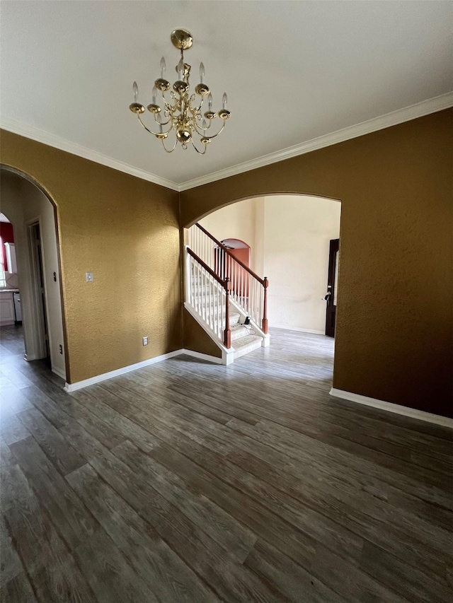 20019 Sterling Meadow Ct, Katy, TX 77449 - spare room featuring arched walkways, crown molding, a chandelier, wood finished floors, and stairway