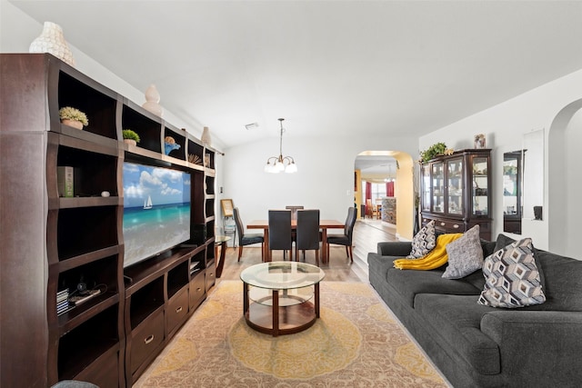 7622 Crestbrook Manor Ln, Cypress, TX 77433 - living area with arched walkways, a chandelier, light wood-type flooring, and vaulted ceiling