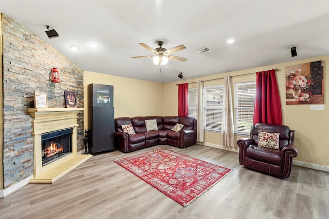7622 Crestbrook Manor Ln, Cypress, TX 77433 - living area with wood finished floors, ceiling fan, and a stone fireplace
