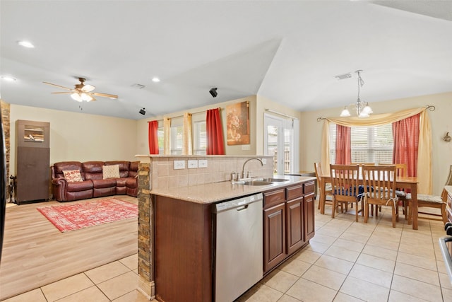 7622 Crestbrook Manor Ln, Cypress, TX 77433 - kitchen featuring stainless steel dishwasher, light tile patterned floors, ceiling fan, a chandelier, and a kitchen island with sink