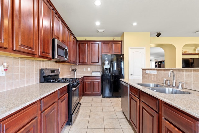 7622 Crestbrook Manor Ln, Cypress, TX 77433 - kitchen with appliances with stainless steel finishes, tasteful backsplash, light tile patterned floors, and dark brown cabinets