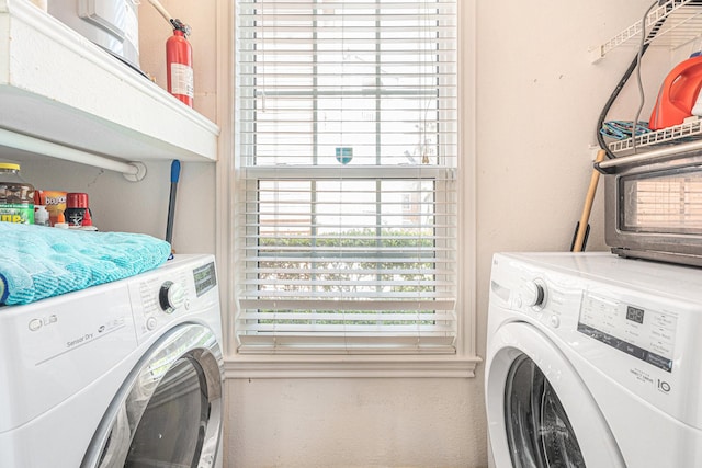 7000 Seawall Blvd Unit 611, Galveston, TX 77551 - laundry room with washing machine and dryer and a textured wall