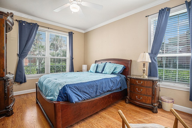 7000 Seawall Blvd Unit 611, Galveston, TX 77551 - bedroom with multiple windows, light wood finished floors, crown molding, and ceiling fan