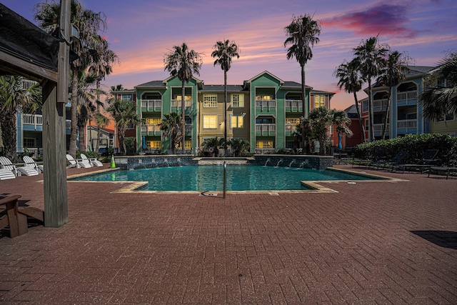 7000 Seawall Blvd Unit 611, Galveston, TX 77551 - pool at dusk with a patio area and a community pool