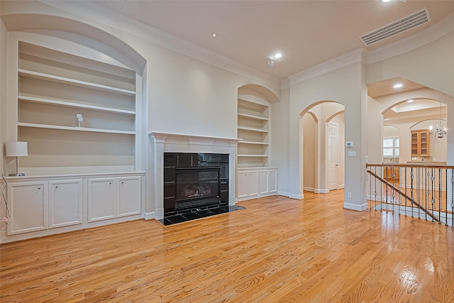 2616 Helena St, Houston, TX 77006 - unfurnished living room with built in shelves, ornamental molding, light wood-style flooring, a fireplace, and recessed lighting