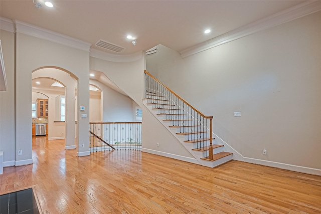 2616 Helena St, Houston, TX 77006 - foyer entrance featuring crown molding, wood finished floors, arched walkways, recessed lighting, and stairs