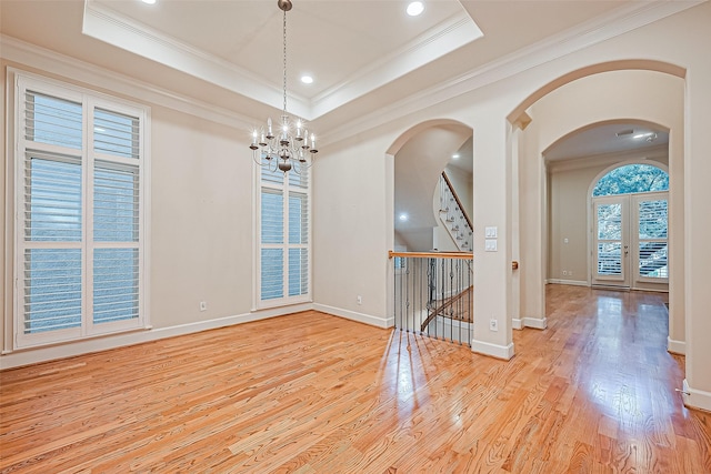 2616 Helena St, Houston, TX 77006 - spare room with arched walkways, wood finished floors, ornamental molding, a chandelier, and stairway