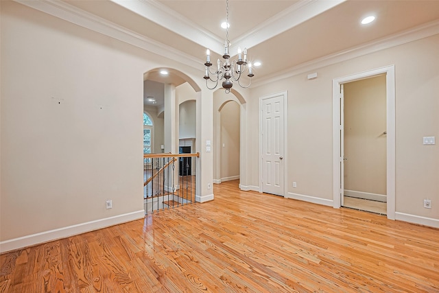 2616 Helena St, Houston, TX 77006 - empty room with ornamental molding, arched walkways, light wood-style floors, recessed lighting, and a chandelier