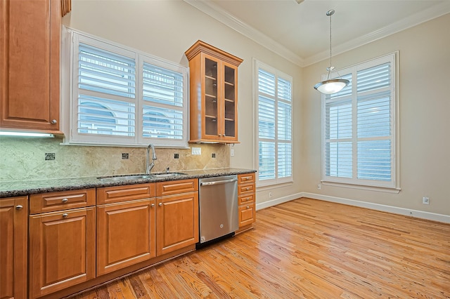 2616 Helena St, Houston, TX 77006 - kitchen with dishwasher, light wood-style flooring, backsplash, brown cabinets, and crown molding