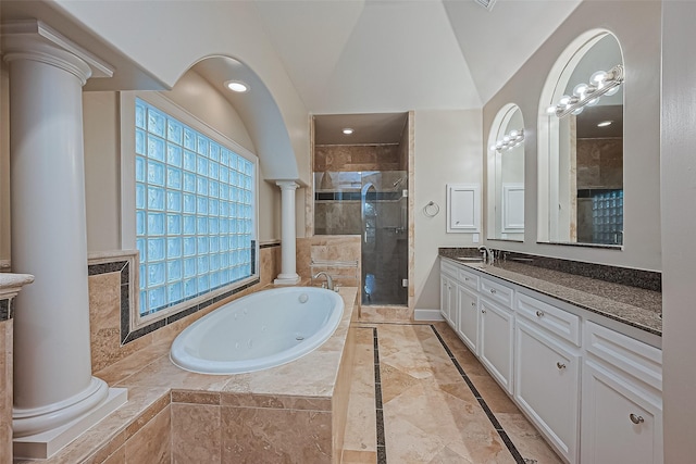 2616 Helena St, Houston, TX 77006 - full bath with decorative columns, vanity, a bath, a stall shower, and vaulted ceiling