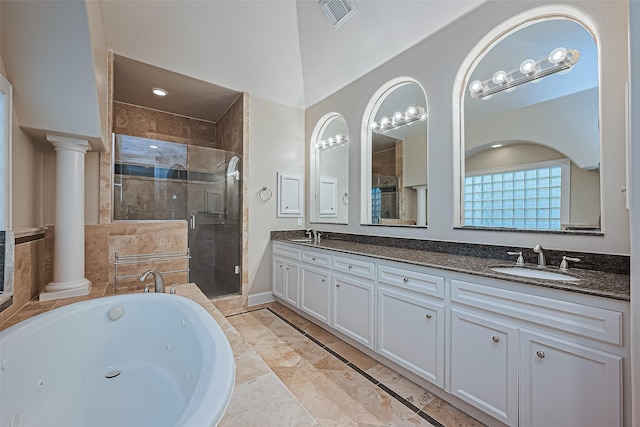 2616 Helena St, Houston, TX 77006 - bathroom featuring a stall shower, double vanity, a whirlpool tub, and ornate columns