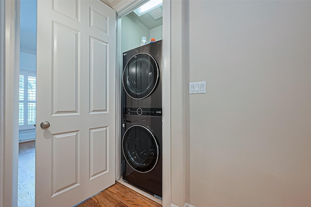 2616 Helena St, Houston, TX 77006 - laundry area featuring stacked washer and clothes dryer and wood finished floors