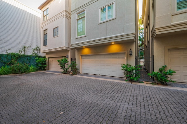 2616 Helena St, Houston, TX 77006 - view of property exterior featuring stucco siding, an attached garage, and driveway