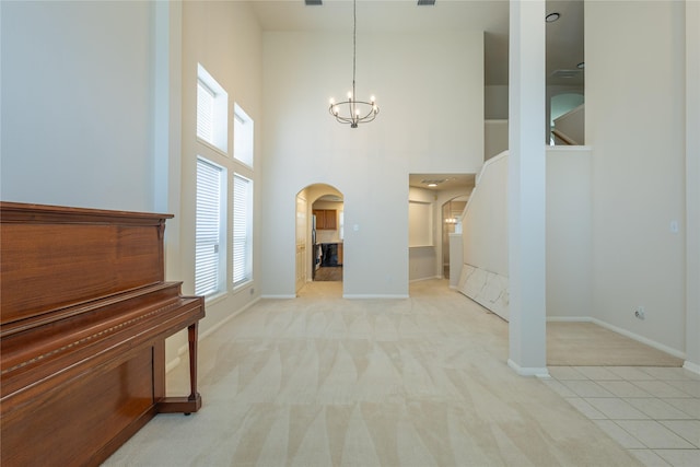 6511 Harcourt Bridge Dr, Houston, TX 77084 - entryway with arched walkways, a chandelier, carpet, and a towering ceiling