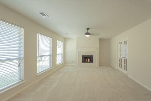 6511 Harcourt Bridge Dr, Houston, TX 77084 - unfurnished living room featuring ceiling fan, light carpet, plenty of natural light, and a fireplace