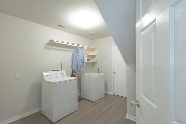 6511 Harcourt Bridge Dr, Houston, TX 77084 - washroom with washer and dryer and light wood finished floors
