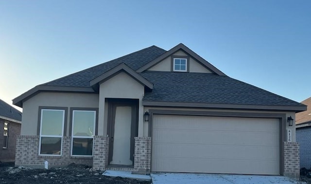 3001 Wild Dunes Dr, Katy, TX 77493 - view of front of home featuring stucco siding, an attached garage, driveway, and roof with shingles