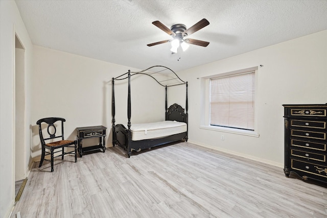3507 Shanemoss Ct, Houston, TX 77068 - bedroom with a textured ceiling, wood finished floors, and a ceiling fan