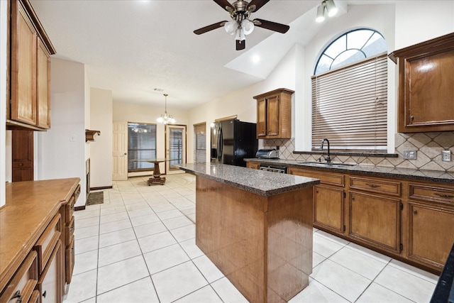 3507 Shanemoss Ct, Houston, TX 77068 - kitchen with black refrigerator with ice dispenser, lofted ceiling, decorative backsplash, a center island, and a chandelier