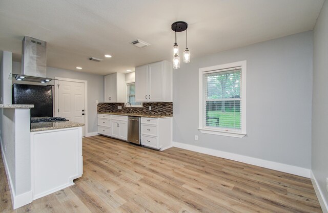 4914 W 43rd St, Houston, TX 77092 - kitchen with extractor fan, stainless steel appliances, light wood-style floors, white cabinetry, and decorative backsplash