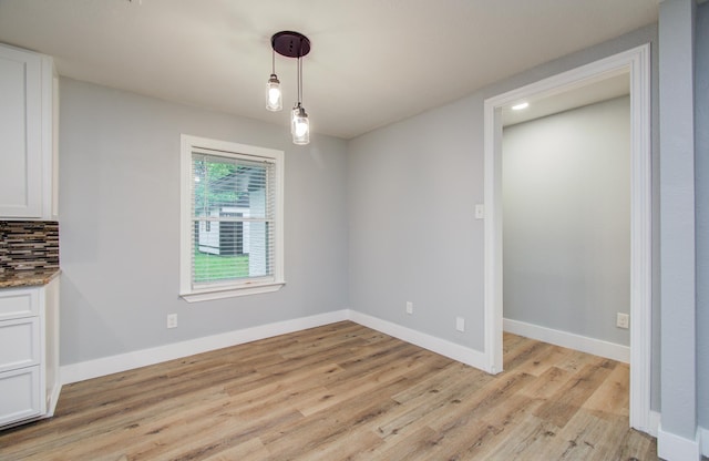 4914 W 43rd St, Houston, TX 77092 - unfurnished dining area with light wood finished floors and baseboards