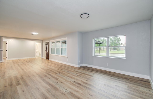 4914 W 43rd St, Houston, TX 77092 - unfurnished living room featuring light wood finished floors and baseboards