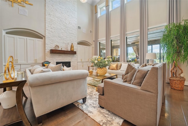 13526 Wedgewood Thicket Way, Cypress, TX 77429 - living area featuring a high ceiling, plenty of natural light, wood-type flooring, and a stone fireplace