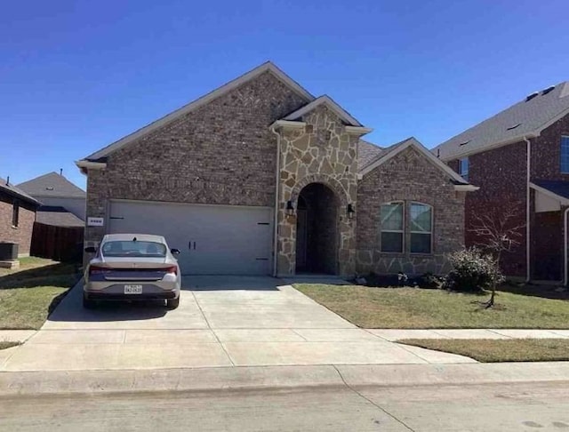 2920 Brady Starr Dr, Aubrey, TX 76227 - view of front of house featuring concrete driveway, an attached garage, stone siding, and brick siding