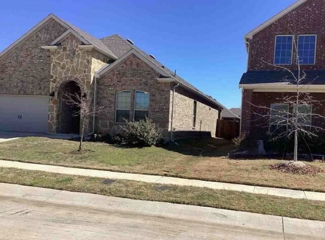 2920 Brady Starr Dr, Aubrey, TX 76227 - view of front facade with brick siding and a front yard