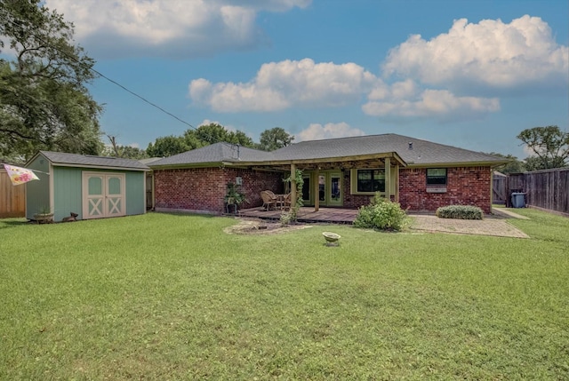 414 Daffodil St, Lake Jackson, TX 77566 - rear view of property with a storage unit, a fenced backyard, a patio, and brick siding