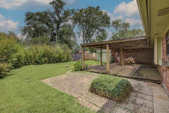 414 Daffodil St, Lake Jackson, TX 77566 - view of yard featuring a storage unit, a deck, and a patio
