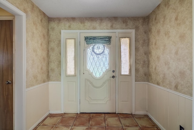 414 Daffodil St, Lake Jackson, TX 77566 - entrance foyer featuring a wainscoted wall and light tile patterned floors