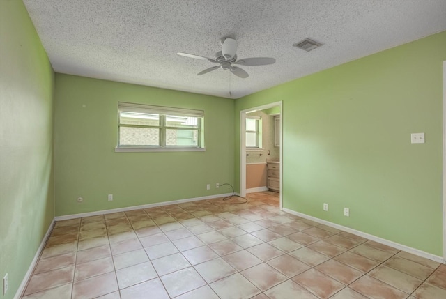 414 Daffodil St, Lake Jackson, TX 77566 - spare room with a ceiling fan, a textured ceiling, and light tile patterned floors