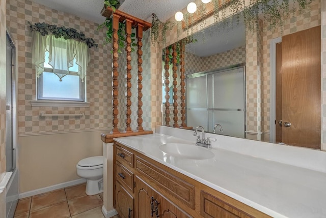 414 Daffodil St, Lake Jackson, TX 77566 - bathroom featuring vanity, tile patterned flooring, wallpapered walls, and a textured ceiling