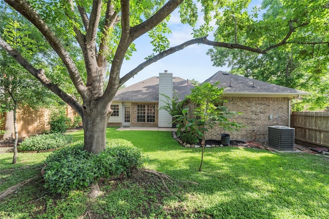 7331 Hazel Cove Dr, Houston, TX 77095 - back of property with brick siding, a chimney, a patio, and a shingled roof