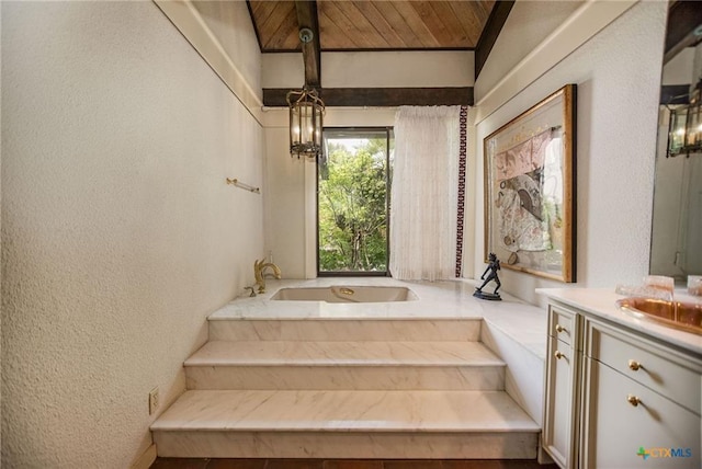 1809 W Harrison Ave, Port O Connor, TX 77982 - full bathroom featuring a textured wall, vanity, and a garden tub