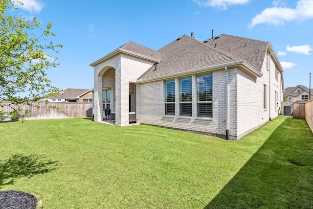 21514 Sunny Riverbank Cir, Cypress, TX 77433 - back of property featuring brick siding, a fenced backyard, and a shingled roof