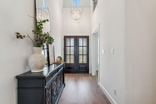 21514 Sunny Riverbank Cir, Cypress, TX 77433 - foyer featuring a chandelier, a high ceiling, french doors, plenty of natural light, and wood finished floors