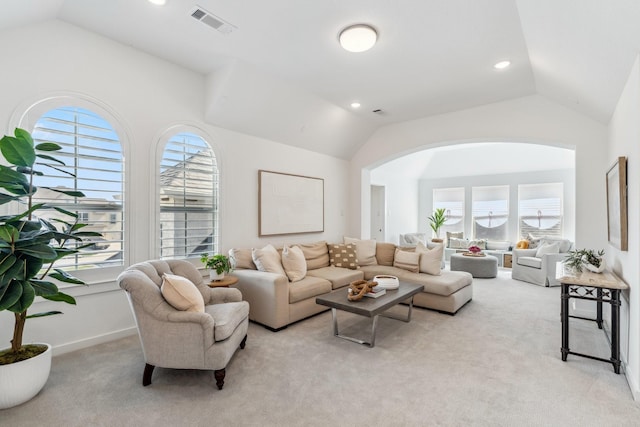 21514 Sunny Riverbank Cir, Cypress, TX 77433 - living room featuring vaulted ceiling, light carpet, arched walkways, and recessed lighting