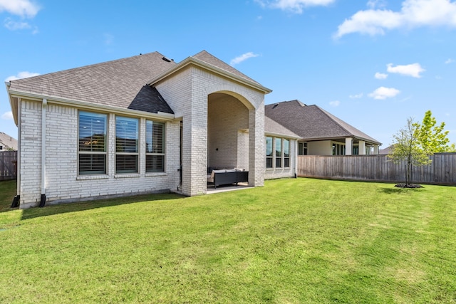 21514 Sunny Riverbank Cir, Cypress, TX 77433 - rear view of house featuring brick siding, an outdoor living space, a shingled roof, and a patio area