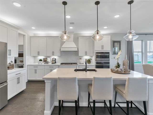 9227 Heckenberg Arbor Ln, Cypress, TX 77433 - kitchen with stainless steel appliances, decorative backsplash, a breakfast bar area, custom exhaust hood, and recessed lighting