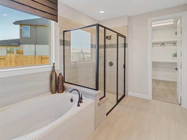 9227 Heckenberg Arbor Ln, Cypress, TX 77433 - bathroom featuring a garden tub, a stall shower, and a walk in closet