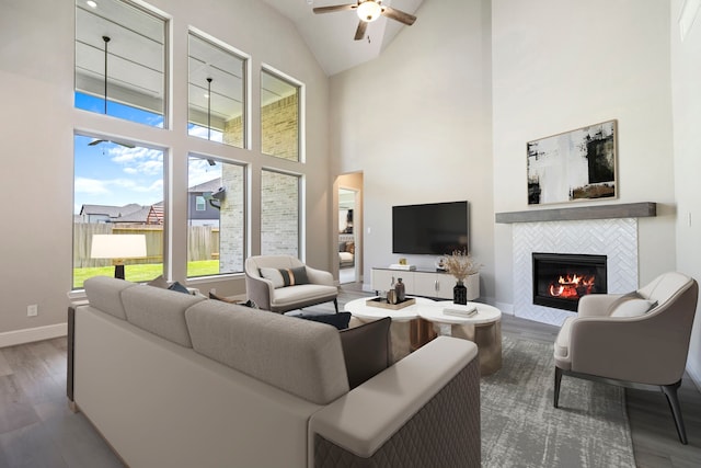 916 Wormwood Dr, League City, TX 77573 - living area with wood finished floors, a tiled fireplace, a ceiling fan, and high vaulted ceiling