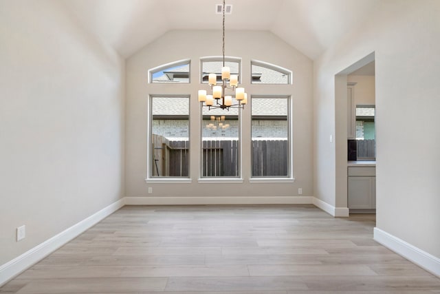 916 Wormwood Dr, League City, TX 77573 - unfurnished dining area with a chandelier, light wood-type flooring, and lofted ceiling