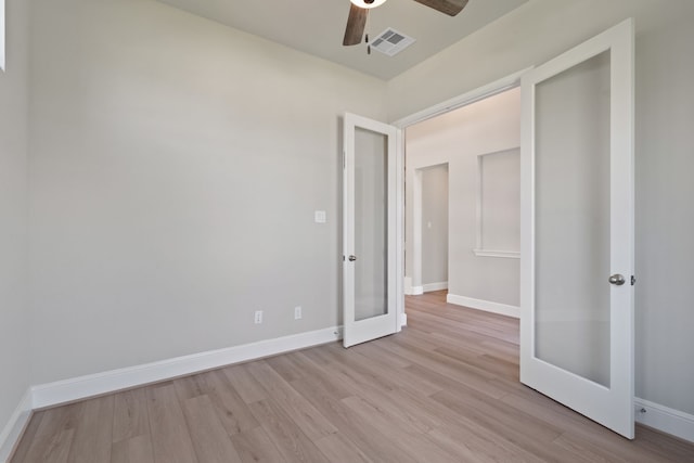 916 Wormwood Dr, League City, TX 77573 - unfurnished bedroom featuring french doors, light wood finished floors, and ceiling fan